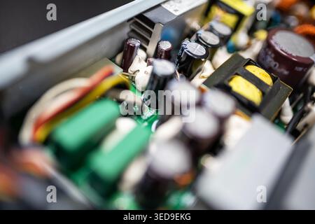 This close-up image showcases intricate electronic circuit board components, emphasizing capacitors, resistors, and connections in a modern technology Stock Photo