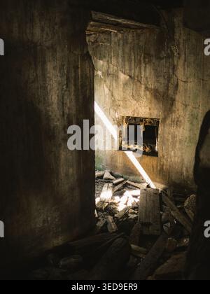 Sunlight piercing through a crumbling Soviet-era bunker interior near Paldiski cliffs, Estonia Stock Photo