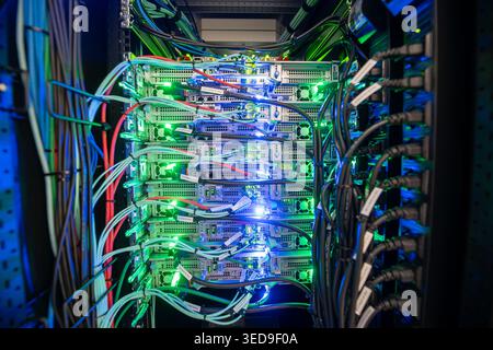 A vibrant data center server rack showcases colorful cables and illuminated components. This image captures the essence of modern technology and conne Stock Photo