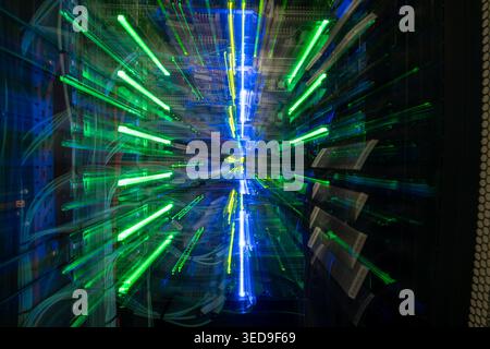 Vibrant light trails illuminate a data center, showcasing the dynamic flow of energy and technology in a mesmerizing abstract visual. Stock Photo