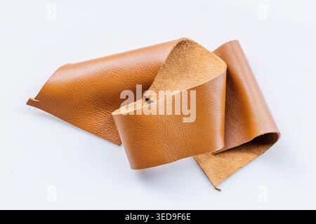 Folded Tan Brown Genuine Leather Piece on White Background, Natural Soft Material Close-Up Stock Photo