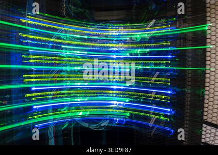 This abstract image features vibrant blue and green lights creating a dynamic motion effect, representing technology, energy, and digital connectivity Stock Photo