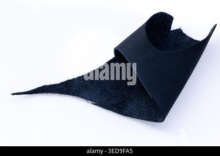 Folded Black Leather Piece Revealing Dark Suede Interior on White Background, Raw Genuine Material Close-Up Stock Photo
