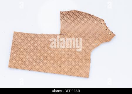 Beige Perforated Leather Sheet with Dot Pattern on White Background, Breathable Craft Material Close-Up Stock Photo
