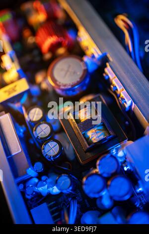 This close-up captures the intricate details of circuit board components, showcasing colorful lights and various electronic parts in a modern design. Stock Photo