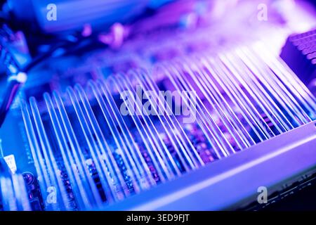 Close-up view of electronic circuit components illuminated with colorful lights. This abstract image highlights the intricate details of technology an Stock Photo