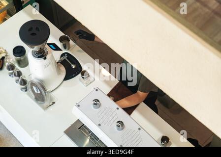 This image depicts a scientist working in a laboratory setting, with various science equipment such as test tubes, chemicals, a microscope, and labora Stock Photo