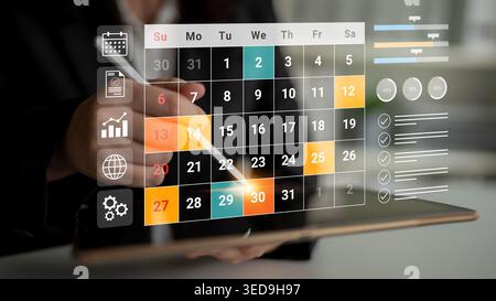 A close-up view of a modern calendar interface displayed on a digital tablet, showcasing tasks, dates, and a user-friendly design for efficient Stock Photo