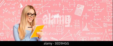 Woman Writing Notes in a Notebook While Studying Math on a Pink Background Stock Photo