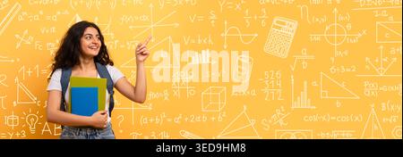Student Stands With Books in Front of Math Wall Filled With Equations and Diagrams Stock Photo