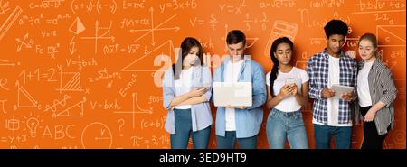 Collection of Students Using Devices in a Learning Space With Math and Science Notes on the Wall Stock Photo