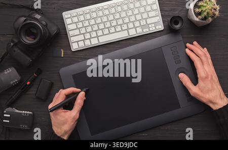 Designer hand with graphic tablet and keyboard Stock Photo