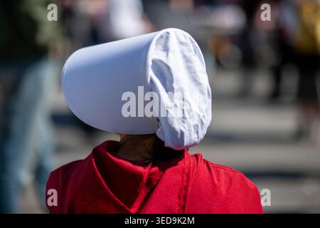 Woman dressed in Handmaid's Tale costume during "May Day" Protest March, marching from Union Square to Washington Square Park, Manhattan, New York Cit Stock Photo