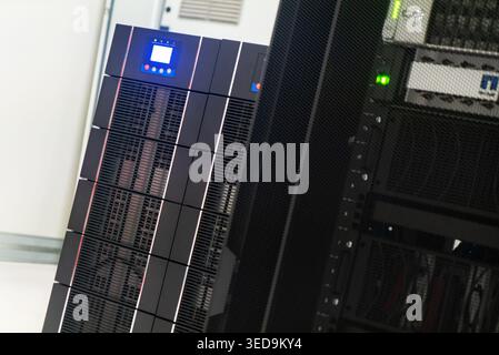 This image showcases a high-tech server rack in a modern data center, emphasizing the advanced technology used for data processing and storage solutio Stock Photo