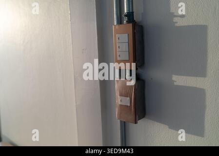 A close-up view of a modern wall switch panel featuring multiple light control buttons, installed on a clean white surface for a contemporary interior Stock Photo