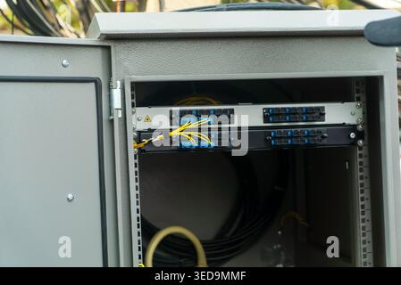 Close-up view of a fiber optic cabinet revealing organized connections and cables, essential for network communication and data distribution in modern Stock Photo