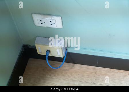 Close-up of an electrical outlet featuring an ethernet connection in a cozy indoor space, highlighting modern tech integration and workspace functiona Stock Photo