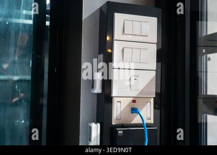 A close-up view of a modern electrical switchboard featuring multiple power switches and outlets, showcasing contemporary design and efficient connect Stock Photo