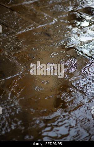 Raindrops falling on a cobble stone street in Florence, Italy Stock Photo