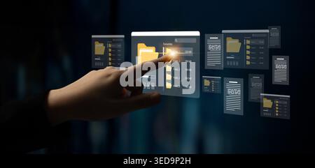 A person interacts with a sleek digital interface that displays virtual files and folders, showcasing advanced technology in modern data management Stock Photo