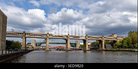 Panoramic view of the Tyne Bridge and High Level Bridge over the River Tyne in Newcastle upon Tyne on a cloudy day Stock Photo