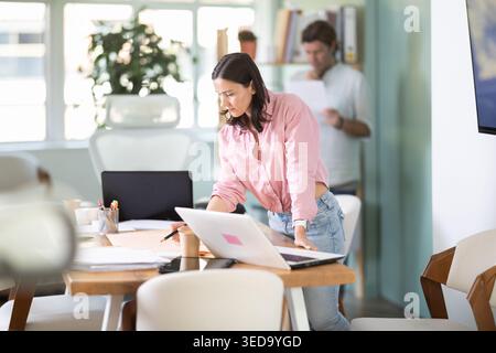Adult man reviewing document, woman looks construction plan Stock Photo