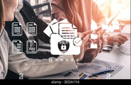 Office employees handle important documents while focusing on security symbols, showcasing teamwork in data management and the importance of Stock Photo