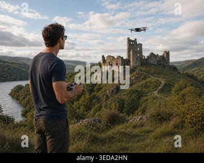 Man operating and  flying a drone quadrocopter ***Original photograph by the contributor, modified using AI tools ** Stock Photo