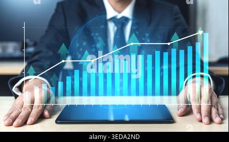 Businessman Analyzing Financial Data with Growth Graph and Chart on Tablet Screen in Modern Office Environment Haptic. Stock Photo