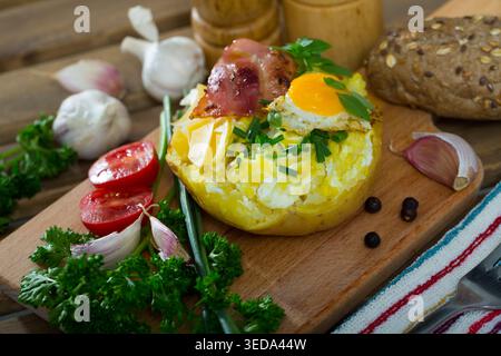 Tasty potato stuffed with eggs, bacon, cheese Stock Photo