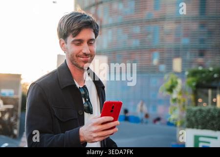 A man engaged in using a smartphone, displaying a focused expression as he enjoys a moment of connection and communication, capturing the essence of Stock Photo