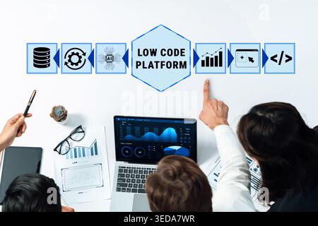 Professionals Collaborating on Low Code Platform Project with Laptop and Visual Data Presentation in Modern Office Setting Quark. Stock Photo