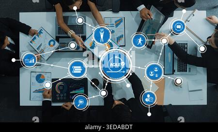A dynamic workspace showcasing collaborative teamwork in an agile environment. Digital interfaces reveal strategies, metrics, and innovation for Stock Photo