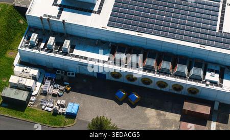 Aerial view of the Data Centre facility featuring solar panels on the roof and large industrial cooling fans along the white facade in Wellingborough, Stock Photo