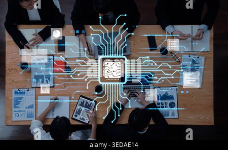 Professionals engage in a collaborative effort on an artificial intelligence project, utilizing technology, charts, and documents in a modern Stock Photo