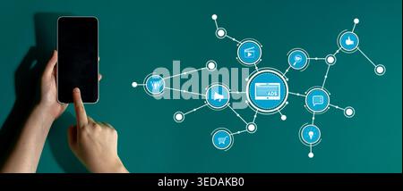 A hand interacts with a smartphone displaying digital marketing icons, symbolizing connectivity, social media interaction, and modern online commerce Stock Photo