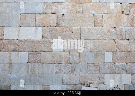 Natural stone wall texture with rectangular blocks in warm earth tones Stock Photo