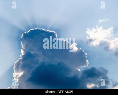 Sun shines from behind a cloud landscape Stock Photo