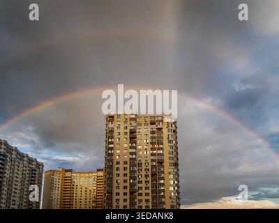 Two beautiful rainbows over buildings city landscape Stock Photo