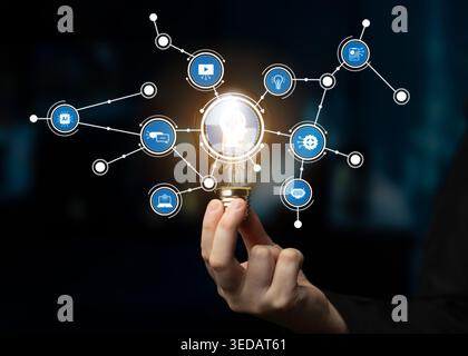 Innovative image showcasing a light bulb surrounded by digital icons representing futuristic ideas and technology, emphasizing creativity and Stock Photo
