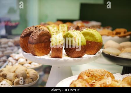 Fresh baked items are arranged on a stand in a bakery Stock Photo