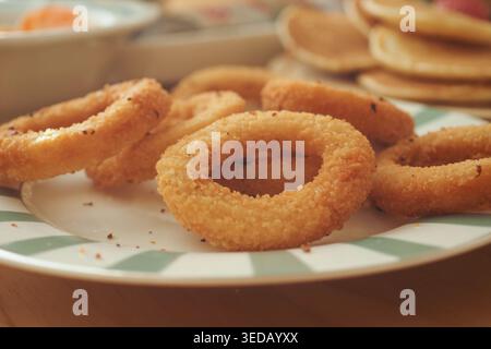 Fried round snacks are placed on a plate with green stripes Stock Photo