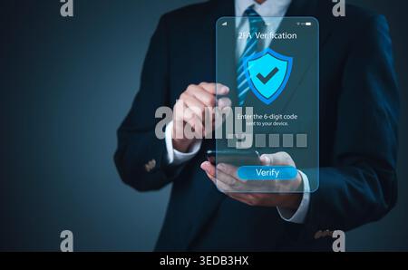 Businessman using smartphone for 2FA two-factor authentication security verification. Mobile banking app concept with shield icon and OTP code entry f Stock Photo