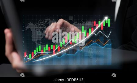 A business professional interacts with a tablet displaying dynamic financial charts and graphs, illustrating crucial market trends and growth insights Stock Photo