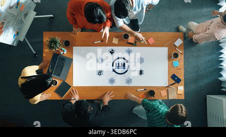 Group of Diverse Professionals Collaborating in a Modern Workspace on Innovative Ideas for Artificial Intelligence Development and Strategy Planning Stock Photo