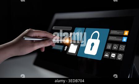 A close-up view of a hand using a stylus on a digital screen featuring cybersecurity icons, emphasizing the importance of secure data protection and Stock Photo