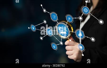 A businesswoman holds a magnifying glass that emphasizes digital icons representing data analysis, networking, and various business concepts Stock Photo