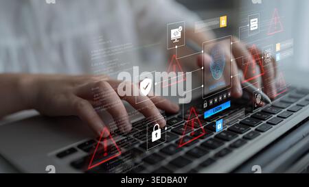 A close-up view of hands typing on a laptop keyboard with visual digital alerts depicting cyber security threats and data protection concepts in a Stock Photo