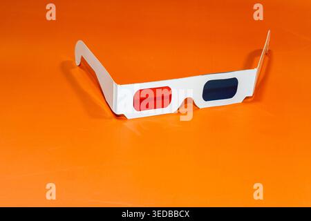 An old 3D glasses in the cinema on an orange surface Stock Photo