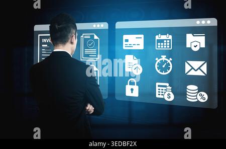 A businessman stands in front of two digital screens, showcasing various icons related to finance, communication, and productivity tools, symbolizing Stock Photo